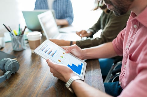 businessman-examining-graphs-digital-tablet-while-planning-with-coworkers-desk-office businessman-examining-graphs-digital-tablet-while-planning-with-coworkers-desk-office
